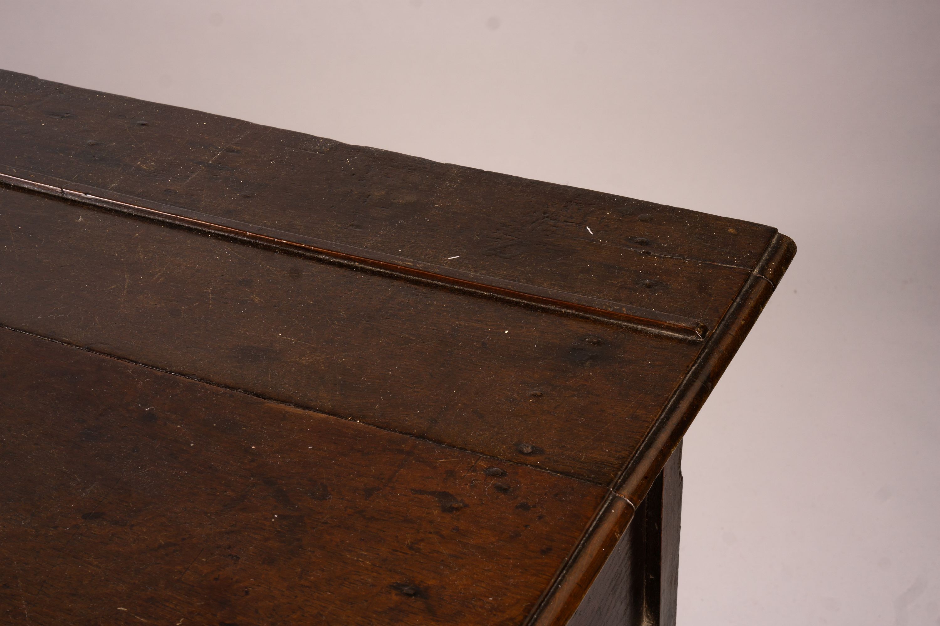 An 18th century oak low dresser on pole turned legs and pad feet, length 198cm, depth 53cm, height 88cm